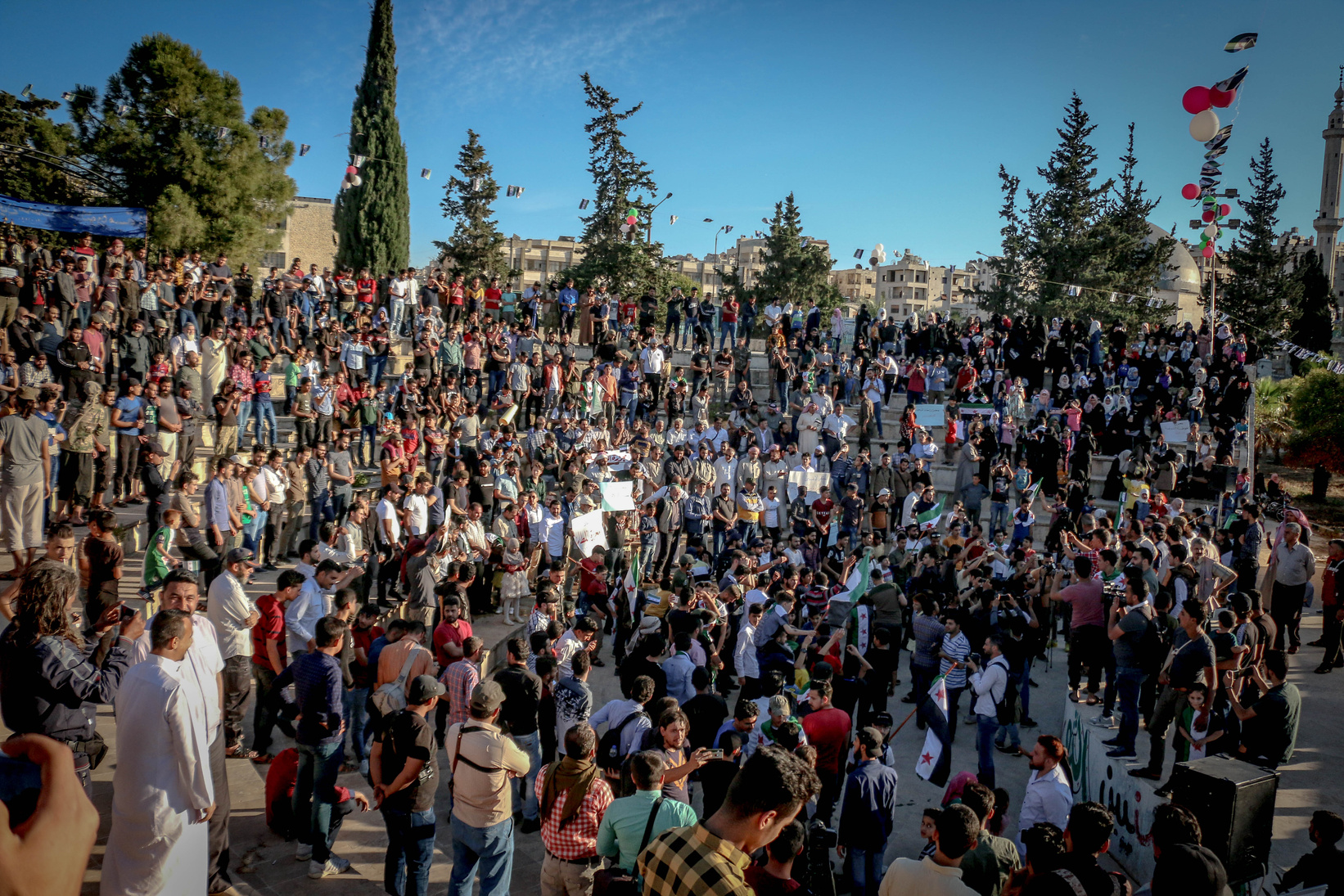 Unrecognizable crowd of ethnic protesters during rally on city street